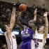 Western Carolina's Harouna Mutombo (22) shoots over Davidson's JP Kuhlman, left, and Nik Cochran, right, during the first half of an NCAA college basketball game for the Southern Conference men's tournament title Monday, March 5, 2012, in Asheville, N.C. (AP Photo/Bob Leverone)
