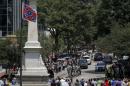 A horse drawn carriage carries the casket of the late South Carolina State Senator Clementa Pinckney past the Confederate flag and onto the grounds of the South Carolina State Capitol in Columbia