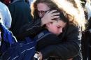 A woman hugs a student at a staging ground set up at the Roswell Mall following a shooting at Berrendo Middle School, Tuesday, Jan. 14, 2014, in Roswell, N.M. A shooter opened fire at the middle school, injuring at least two students before being taken into custody. Roswell police said the school was placed on lockdown, and the suspected shooter was arrested. (AP Photo/Roswell Daily Record, Mark Wilson)