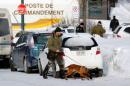 Police officers patrol the perimeter at the scene of a fatal shooting at the Quebec Islamic Cultural Centre in Quebec City