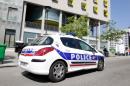 A police vehicle is parked outside the residence where an IT student -- suspected of planning a church attack -- lived in Paris, on April 22, 2015