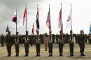 File photo of Thai soldiers carrying national flags as they participate in the opening ceremony of the annual joint "Cobra Gold 2010" (CG10) military exercise at U-tapao airport in Rayong province