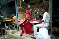 In this photo provided on Friday Feb. 10, 2012 by World Press Photo, the 2nd prize Arts and Entertainment Singles category of the 2012 World Press Photo contest by Vincent Boisot, France, Riva Press for Le Figaro Magazine, shows a model posing in front of tailor stalls in the center of Dakar, Senegal, July 9, 2011. She wears the creation of a designer, Yolande Mancini, participating in the 9th edition of Dakar Fashion Week. (AP Photo/Vincent Boisot/Riva press for Le Figaro Magazine)