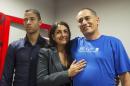 Baez, a member of the International Contingent Brigade "Henry Reeve", who was infected with Ebola in Sierra Leone, poses for a photo with his wife and son during a news conference in Havana