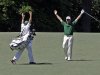 Louis Oosthuizen, of South Africa, and his caddie Wynand Stander react after Oosthuizen's double eagle two on the par 5 second hole during the fourth round of the Masters golf tournament Sunday, April 8, 2012, in Augusta, Ga. (AP Photo/Matt Slocum)
