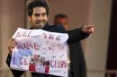 Actor Roth gestures as he holds a banner, which he had received from fans, on "A Dangerous Method" red carpet at 68th Venice Film Festival