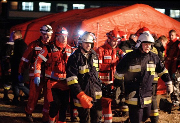 Polish emergency services carry a casualty at the site of a train crash near the town of Szczechociny