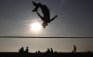 Dan Campbell somersaults as he practices slackline on Brighton beach in southeast England