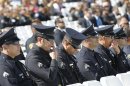Police officers watch the funeral service for Riverside Police Officer Michael Crain outside Grove Community Church in Riverside