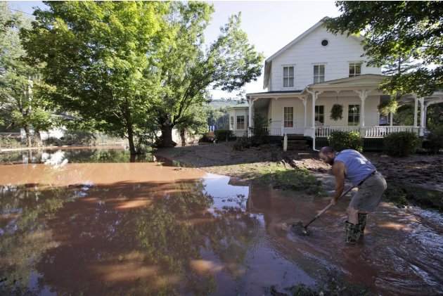 Michael Lancto digs a drain for water to flow away from his and others houses after Tropical Storm Irene flooded parts of the town, Tuesday, Aug. 30, 2011 in Windham, N.Y. Officials say more than a do