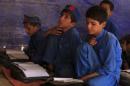 Boys attend a class at a school in Kababiyan refugee camp in Peshawar, Pakistan,