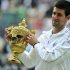 Djokovic holds the trophy after beating Rafael Nadal in last year's Wimbledon men's singles final