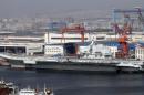 A general view shows navy soldiers standing on China's first aircraft carrier "Liaoning" as it is berthed in a port in Dalian