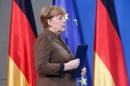 German Chancellor Merkel walks before delivering a statement in Berlin