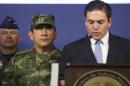 Colombia's new armed forces commander General Juan Pablo Rodriguez listens as Colombian Defense Minister Juan Carlos Pinzon speaks during a news conferences at the Ministry of Defense building in Bogota