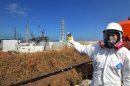 A journalist checks the radiation level at the Fukushima Dai-ichi nuclear power plant in February 2012