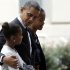 President Barack Obama hugs his daughter Sasha as he walks with Malia as they leave St. John's Episcopal Church to walk across Lafayette Park as they return to the White House in Washington, on Sunday, Oct. 28, 2012. (AP Photo/Jacquelyn Martin)