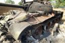 A photo taken on March 15, 2015 in Madagali and released by the Nigerian Army press service shows a Boko Haram tank destroyed during the battle of Madagali troops in eastern Nigeria Adamawa State