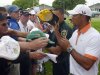 Tiger Woods, right, signs autographs for fans after finishing his weather-shortened round on the ninth green of the pro-am of the Arnold Palmer Invitational golf tournament in Orlando, Fla., Wednesday, March 20, 2013.(AP Photo/Phelan M. Ebenhack)