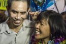 Human rights activist Nguyen Quoc Quan with his wife Huong Mai Ngo smile during a news conference after his arrival at the Los Angeles International Airport from Vietnam on Wednesday, Jan. 30, 2013, in Los Angeles. Quan has been released after being detained since April 17, 2012 in Ho Chi Minh City, Vietnam. (AP Photo/Ringo H.W. Chiu)