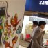 People walk at a Samsung Electronics store in Seoul
