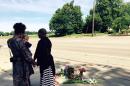 Pastor Patricia Bell (R) of St. Paul, Minnesota, prays with Gabriella Dunn and her children at the scene of the shooting of Philando Castile on July 7, 2016
