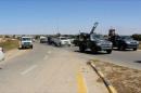 Still image of forces aligned with Libya's new unity government are seen on the road as they advance on the eastern and southern outskirts of the Islamic State stronghold of Sirte