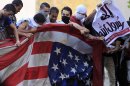 Photos: Protesters pull down U.S. flag at Cairo embassy