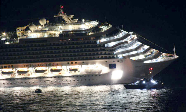 Rescuers surround the luxury cruise ship Costa Concordia after it ran aground off the coast of Isola del Giglio island, Italy, gashing open the hull and forcing some 4,200 people aboard to evacuate ab
