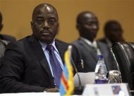 Democratic Republic of Congo's President Joseph Kabila (L) listens to deliberations during the International Conference on the Great Lakes Region (ICGLR) at the Commonwealth Resort Hotel Munyonyo in the capital of Kampala August 8, 2012. REUTERS/Edward Echwalu