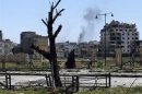 Smoke rises after what activists said was shelling by forces loyal to Syria's President Bashar al-Assad in Homs