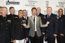 Actor Robert Downey Jr., center, poses with members of the U.S. Military and New York Fire Department before the premiere of 