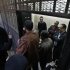 Egyptian policemen stand  in front of  Egyptian employees of several pro-democracy groups charged with using foreign funds to foment unrest during their trial in Cairo, Egypt, Sunday, Feb. 26, 2012. Egypt went forward with a trial Sunday that has plunged relations with the U.S. into the deepest crisis in decades, prosecuting 16 Americans and 27 other employees of pro-democracy groups. (AP Photo/Khalil Hamra)
