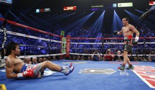 Juan Manuel Marquez, from Mexico, left, knocks down Manny Pacquiao, from the Philippines, in the third round of their WBO world welterweight fight Saturday, Dec. 8, 2012, in Las Vegas. (AP Photo/Eric Jamison)