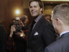 New England Patriots quarterback Tom Brady talks to a friend as he leaves a news conference on Sunday, Jan. 29, 2012, in Indianapolis. The Patriots are scheduled to face the New York Giants in Super Bowl XLVI on Feb. 5. (AP Photo/Mark Humphrey)