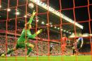 Bournemouth's goalkeeper Artur Boruc (L) saves a shot from Liverpool's Christian Benteke (3rd R) during the English Premier League match at the Anfield stadium in Liverpool on August 17, 2015