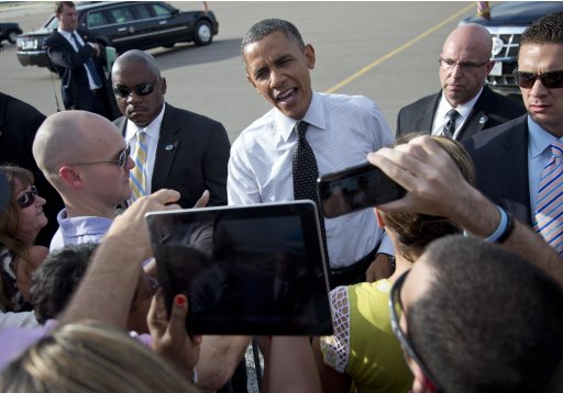 President Barack Obama greets people on the tarmac as he arrives at Tampa International Airport on Air Force One, Thursday, Sept. 20, 2012, in Tampa.  (AP Photo/Carolyn Kaster)