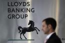 File photograph shows a pedestrian passing the head office of the Lloyds Banking Group in London