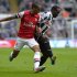 Newcastle's Mapou Yanga-Mbiwa challenges Arsenal's Theo Walcott during their English Premier League soccer match at St James' Park Newcastle, northern England