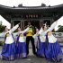 In this photo provided by Puma, Jamaican athlete Usain Bolt, center, poses for a photograph with women in traditional Korean dress at the Dalgubal Grand Bell in Daegu, South Korea, Saturday, Aug. 20, 2011. (AP Photo/Puma, Chung Sung-Jun) EDITORIAL USE ONLY