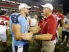 Tennessee Titans quarterback Jake Locker (10) is congratulated by Arizona Cardinals head coach Ken Whisenhunt after the Titans beat the Arizona Cardinals 32-27 in an NFL football preseason game on Thursday, Aug. 23, 2012, in Nashville, Tenn. Locker threw for 134 yards and two touchdowns in his home debut as the Titans' starting quarterback. (AP Photo/Joe Howell)