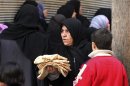 A woman carries bread in Aleppo