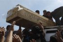 Residents carry the coffin of a victim, who was killed in a bomb attack, during a funeral in Najaf