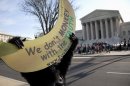 Protesters, including a man in a monkey suit, gather at the Supreme Court in Washington, Wednesday, March 28, 2012, as the court concludes three days of hearing arguments on the constitutionality of President Barack Obama's health care overhaul. (AP Photo/Carolyn Kaster)