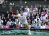 Andy Murray of Britain hits a return to Jo-Wilfried Tsonga of France during their men's semi-final tennis match at the Wimbledon tennis championships in London