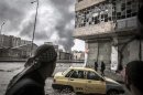 In this Thursday, Oct. 25, 2012 photo, smoke rises from the Karmal Jabl neighborhood, during clashes between rebel fighters and the Syrian army in Aleppo, Syria. (AP Photo/Narciso Contreras)