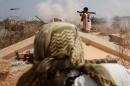 Libyan forces allied with the U.N.-backed government fire weapons during a battle with Islamic State fighters in Sirte