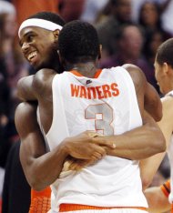 Syracuse guard Dion Waiters (3) and forward C.J. Fair, rear, celebrate their 64-63 win over Wisconsin in the second half of an East Regional semifinal game in the NCAA men's college basketball tournament, Thursday, March 22, 2012, in Boston. (AP Photo/Michael Dwyer)