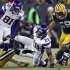 Minnesota Vikings' Adrian Peterson is brought down by Green Bay Packers' Brad Jones during their NFL NFC wildcard playoff football game in Green Bay