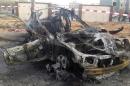 The wreckage of a car is pictured after a bomb exploded outside the Ajdabiya?s Security Directorate headquarters